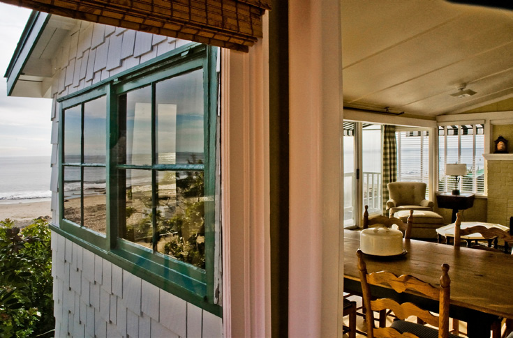 Exterior picture of Cottage #14 with a peek inside of the door. Crystal Cove State Park