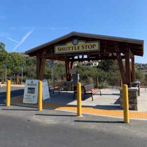 wooden shuttle stop with yellow bollards