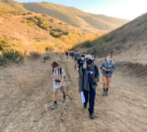 A Conservancy staff member leads high school interns up a trail in the backcountry.