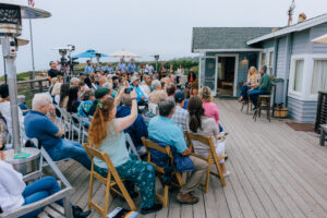 Wade Crowfoot and Kate Wheeler speaking in front of a seated audience