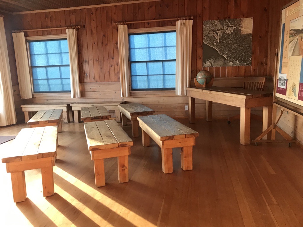 Japanese American school house exhibit with wooden benches