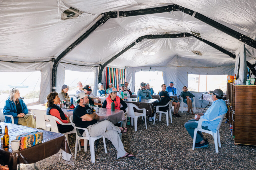 Group of people sitting in a large tent