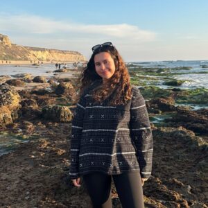 Woman standing at some seaweed covered tide pools
