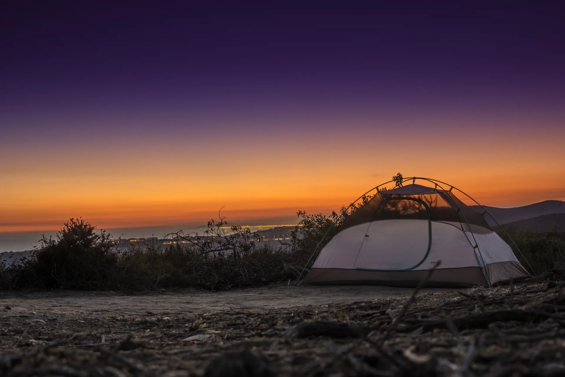 white tent on a dirt hill during dusk